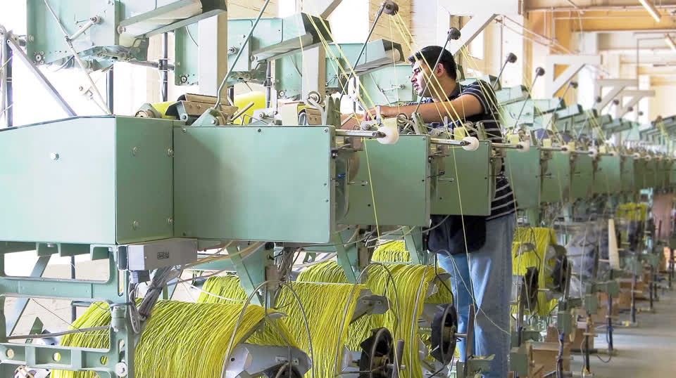 Man working at a winding machine